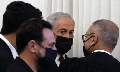  ?? Photograph: Maya Alleruzzo/EPA ?? Benjamin Netanyahu (second right) is flanked by lawyers before the testimony by Nir Hefetz at Jerusalem district court.