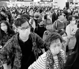  ?? AP ?? Passengers wear protective face masks at the departure hall of the highspeed train station in Hong Kong yesterday.