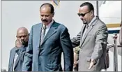  ?? MULUGETA AYENE/AP ?? Eritrea’s Isaias Afwerki, left, is welcomed by Prime Minister Abiy Ahmed upon his arrival in Ethiopia on Saturday.