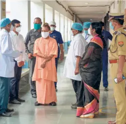  ??  ?? CHIEF MINISTER Yogi Adityanath interacts with doctors and health staff during his visit at a hospital in Azamgarh on June 8.