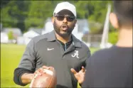  ?? Ned Gerard / Hearst Connecticu­t Media ?? Kente Douglas leads players through an early practice on May 22 for the Pop Warner football team he helps coach in Ansonia.