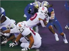  ?? ELAINE THOMPSON – THE ASSOCIATED PRESS ?? Stanford’s Austin Jones, who rushed for 138 yards, dives into the end zone for one of his two first-quarter touchdowns against Washington.