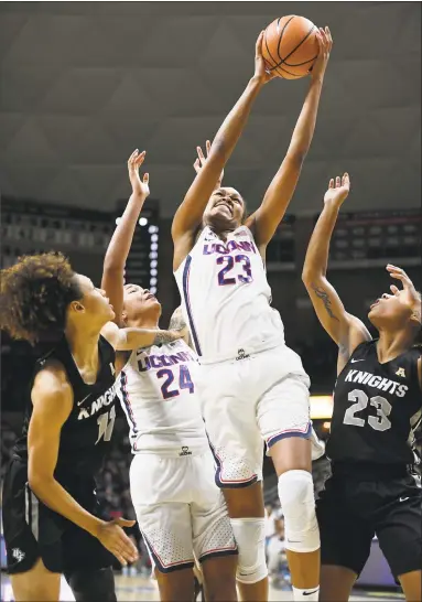  ?? Jessica Hill / Associated Press ?? UConn’s Azura Stevens (23) pulls down a rebound against Central Florida’s Kayla Thigpen (11) and Lawriell Wilson as UConn’s Napheesa Collier defends during Tuesday night’s game at Gampel Pavilion in Storrs.
