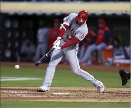  ?? JED JACOBSOHN – THE ASSOCIATED PRESS ?? The Angels’ Shohei Ohtani hits a single during the fifth inning of Tuesday’s game at Oakland. Ohtani also homered and picked up his 10th victory of the season on the mound.