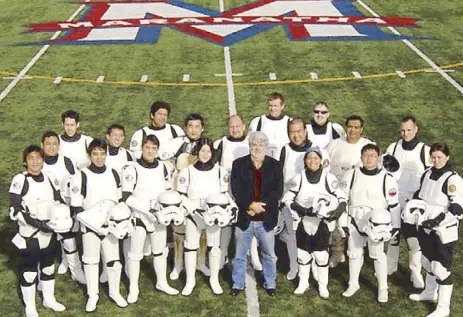  ??  ?? Force field: The internatio­nal members of the 501st Legion posing with George Lucas at the Parade of Roses in Pasadena. (Rejj is on the right of George, wearing the bandana.)