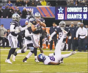  ?? Andrew Savulich / Tribune News Service ?? The Cowboys’ Sean Lee intercepts a tipped pass by Giants quarterbac­k Eli Manning in the fourth quarter Sunday in East Rutherford, N.J.