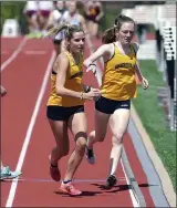  ??  ?? Unionville’s Molly Main hands to Josie Cicchino the 4x800 relay. The team won in a time of 9.51.17.