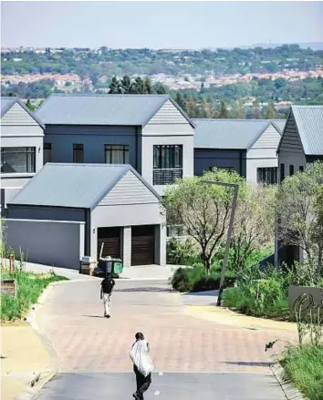  ?? AFP ?? Gated community A worker walks on one of the empty streets of the newly-built enclosed lifestyle housing complex of Steyn city in Midrand.