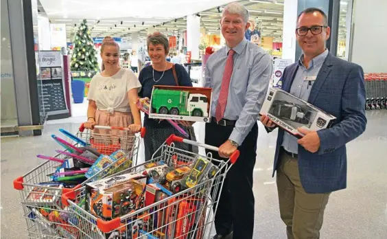  ??  ?? CHRISTMAS SHOP: Shopping for toys to donate are (from left) Selma Steinholt, Roslyn Hooper, Peter Snow and Shane Dore.