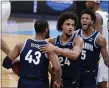  ?? MIKE CONROY — THE ASSOCIATED PRESS ?? Villanova forward Jeremiah Robinson-Earl, center, celebrates a play with Eric Dixon, left, and Justin Moore during the first half of Saturday’s Sweet 16loss to Baylor. Dixon, an Abington graduate, and Moore are two of the key pieces Villanova will lean on to rebuild after this season’s departures.