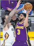  ?? Ashley Landis The Associated Press ?? Lakers forward Anthony Davis eyes the basket against Pelicans center Steven Adams in the second quarter of Los Angeles’ 112-95 win Friday at Staples Center. Davis scored 17 points.