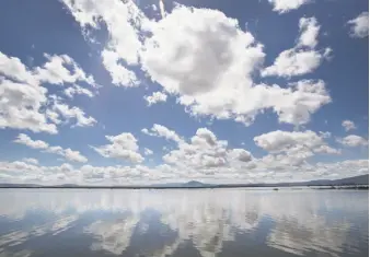  ?? Paul Kuroda / Special to The Chronicle ?? Clouds reflect on the water surface of the Lower Klamath National Wildlife Refuge in Siskiyou County. The refuge, establishe­d in 1908, was the first waterfowl refuge in the United States.