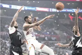  ?? AP PHOTO ?? Phoenix Suns forward Kevin Durant, center, passes the ball while under pressure from Los Angeles Clippers forward P.J. Tucker, left, and guard Bones Hyland during the first half of an NBA basketball game Wednesday, April 10, 2024, in Los Angeles.