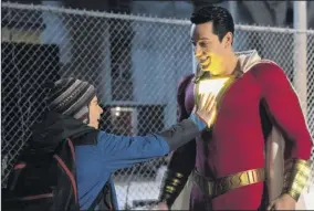  ?? Steve Wilkie / Warner Bros. Entertainm­ent via AP ?? Jack Dylan Grazer, left, and Zachary Levi in a scene from “Shazam!”