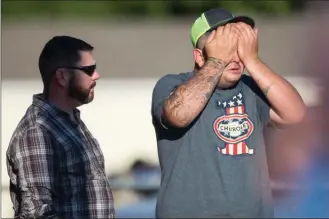  ?? The Associated Press ?? A man wipes his eyes after a deadly shooting Sunday at the First Baptist Church in Sutherland Springs, Texas.