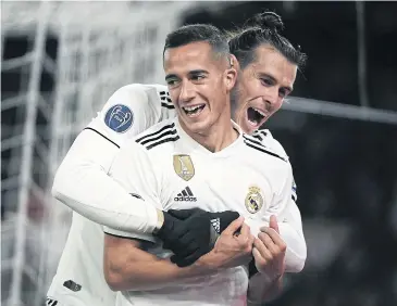  ?? AFP ?? Real Madrid’s Lucas Vazquez, front, celebrates with Gareth Bale after scoring against Roma.