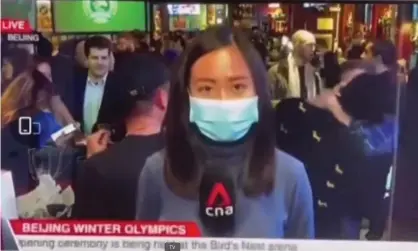  ?? ?? Two men are seen kissing behind the Channel News Asia reporter during a live broadcast from Beijing. Photograph: CNA/YouTube