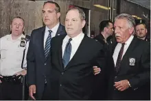  ?? RICHARD DREW THE ASSOCIATED PRESS ?? Harvey Weinstein is escorted in handcuffs to a courtroom in New York on Monday. Weinstein was due in court for arraignmen­t on charges alleging he committed a sex crime against a third woman.