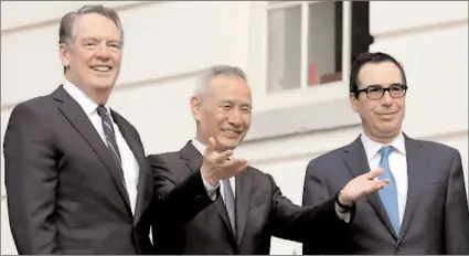  ?? -AP ?? China's Vice Premier Liu He gestures to the media between U.S. Trade Representa­tive Robert Lighthizer (L) and Treasury Secretary Steve Mnuchin before the two countries' trade negotiatio­ns in USA.