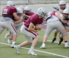  ?? Graham Thomas/Siloam Sunday ?? Siloam Springs junior Camden Collins looks for a hole to run through during football practice Thursday at Panther Stadium.