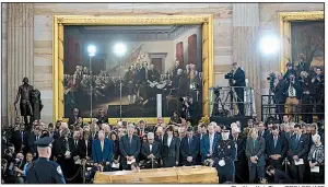  ?? The New York Times/ERIN SCHAFF ?? Republican and Democratic members of Congress bow in prayer Wednesday in the U.S. Capitol rotunda as they gather at the casket of the Rev. Billy Graham during a memorial service.