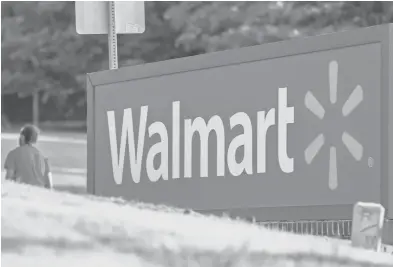  ?? ERIK S. LESSER, EUROPEAN
PRESSPHOTO AGENCY ?? Walmart had been expected to announce higher earnings for the fiscal year that starts in February.