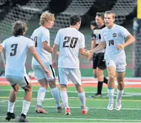  ?? JON CUNNINGHAM/DAILY SOUTHTOWN ?? Lincoln-Way West’s Ross DeGroot, right, celebrates with his teammates after scoring the first goal against Lincoln-Way Central during a game in New Lenox on Oct. 5.