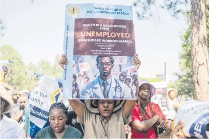  ?? Picture: AFP ?? DYING TO SERVE. Health workers hold placards during a demonstrat­ion led by the South African Medical Associatio­n Trade Union for unemployed health workers, at the Union Building in Pretoria yesterday.