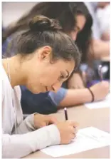  ??  ?? Rachel Bossong, an exceptiona­l education teacher at Lookout Valley Middle/High, takes a math quiz during the orientatio­n event.