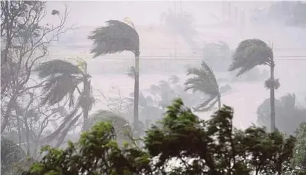  ?? EPA PIC ?? Strong winds and rain lashing Airlie Beach in Queensland yesterday.