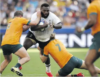  ?? ?? Australia’s James Slipper (left) and Fraser Mcreight tackle Fiji’s Luke Tagi during the Rugby World Cup in Saint-étienne in France on 17 September 2023. Photo: Yoan VALAT/EPA-EFE