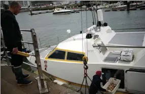  ?? (AP/Christophe Ena) ?? French fishermen empty their boat Friday at the port of Boulogne-sur-Mer in northern France.