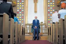  ?? Kriston Jae Bethel, © The New York Times Co. ?? On the campaign trail in September, Joe Biden prays before the start of a community meeting at Grace Lutheran Church in Kenosha, Wis.