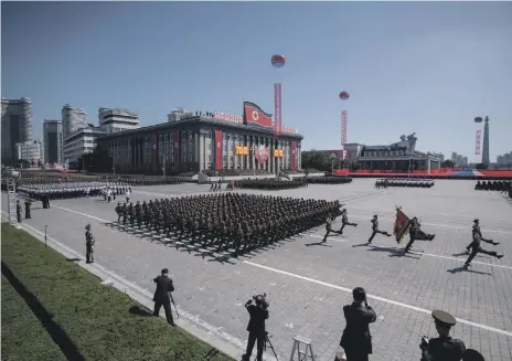  ??  ?? Korean People’s Army soldiers mark the 70th anniversar­y of the foundation of North Korea, in Kim Ilsung Square, Pyongyang, yesterday; in contrast, left, a parade in April last year to mark the 105th anniversar­y of late leader Kim Il-sung‘s birth featured a display of missile might