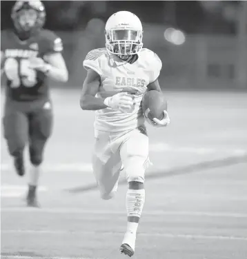  ?? JOHN MCCALL/SOUTH FLORIDA SUN SENTINEL ?? Atlantic wide receiver Tyler Burke returns the kickoff for a touchdown against Boca Raton on the first play of the game on Friday night.