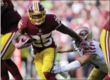  ?? MARK TENALLY — THE ASSOCIATED PRESS ?? Washington running back Chris Thompson (25) ball during Sunday’s win over the 49ers. carries the