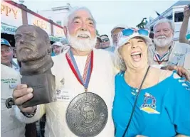  ?? ANDY NEWMAN/AP ?? Michael Groover, left, husband of celebrity chef Paula Deen, celebrates after winning the Hemingway Look-Alike Contest at Sloppy Joe's Bar in Key West.