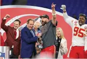  ?? Rob Carr/Getty Images ?? Travis Kelce and Chris Jones of the Kansas City Chiefs celebrate with the Lamar Hunt Trophy as Jim Nantz looks on after a 17-10 victory against the Baltimore Ravens in the AFC Championsh­ip Game on Sunday.