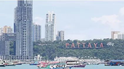  ?? WICHAN CHAROENKIA­TPAKUL ?? Tourist boats anchored at Pattaya Beach. Before the fresh outbreak flared up in Bangkok, hotels in Pattaya were fully booked.