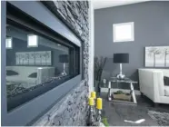  ??  ?? A beautiful stone feature wall and fireplace creates a warm and cosy focal point in Fraser Homes’ latest show home.
