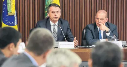  ?? MARCOS CORREA AFP/GETTY IMAGES ?? Brazilian President Jair Bolsonaro, left, and chief of staff Onyx Lorenzoni attend their first ministeria­l meeting in Brasilia on Thursday.