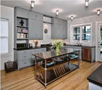 ?? Miro Dvorscak photos ?? A beautiful kitchen now sits at what was the back of a deteriorat­ing apartment in the Dentler building. When Laura and Evan Michaelide­s acquired the building, they acquired a long to-do list that including remedying termite and water damage, among...