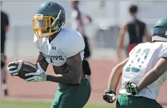  ?? Katharine Lotze/The Signal (See additional photos on signalscv.com) ?? Canyon’s Brandon Wilson carries the ball past the defense during practice on Thursday.