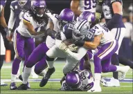  ?? Getty Images ?? Ezekiel Elliott of the Dallas Cowboys is brought down Sunday by members of the Minnesota Vikings at AT&T Stadium.