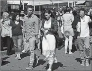  ?? DANA JENSEN/THE DAY ?? Stars Chad Michael Murray and Aly Michalka, center, walk through the fair set Friday as they head back to their mark to run through a scene again during a rehearsal while filming the Hallmark movie “Sand Dollar Cove” at the Noank Town Dock in Groton.