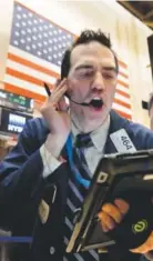  ?? Richard Drew, The Associated Press ?? Trader Gregory Rowe works on the floor of the New York Stock Exchange on Tuesday. U. S. stocks opened modestly higher as the market recovered froma loss the day before.