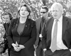  ?? — AFP photo ?? Johnson (right) and New Zealand’s Conversati­on Minister Maggie Barry, visit the Zealandia wildlife santuary in Wellington.