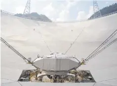  ?? — AFP photo ?? A workers at the centre of the Five-hundred-metre Aperture Spherical Radio Telescope (FAST) in Pingtang, in southweste­rn China’s Guizhou province.