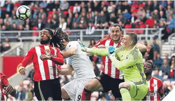  ??  ?? Fernando Llorente of Swansea City heads his side’s first goal past Jordan Pickford.