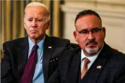  ?? ?? Joe Biden and the education secretary, Miguel Cardona. The Department of Education penalized Mohela for its mistakes at the end of October. Photograph: Demetrius Freeman/The Washington Post via Getty Images